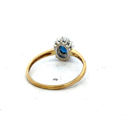 18ct yellow gold sapphire and diamond ring by Reeves and Sons, size L1/2, featuring a central sapphire with diamond accents.