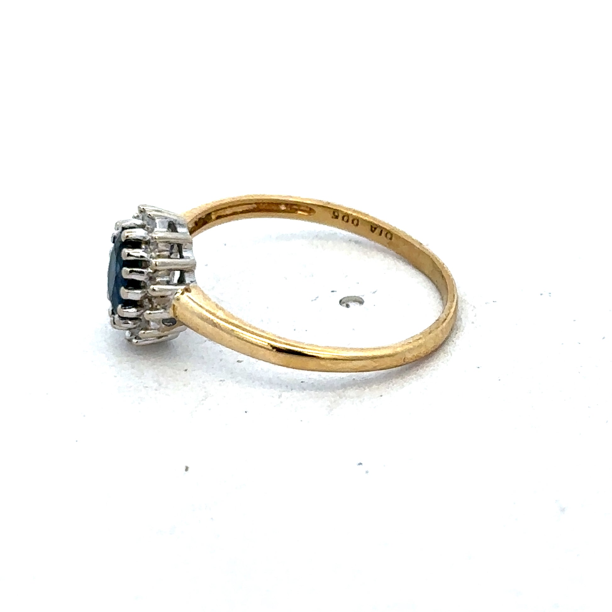 18ct yellow gold sapphire and diamond ring by Reeves and Sons, size L1/2, featuring a central sapphire and sparkling diamonds.