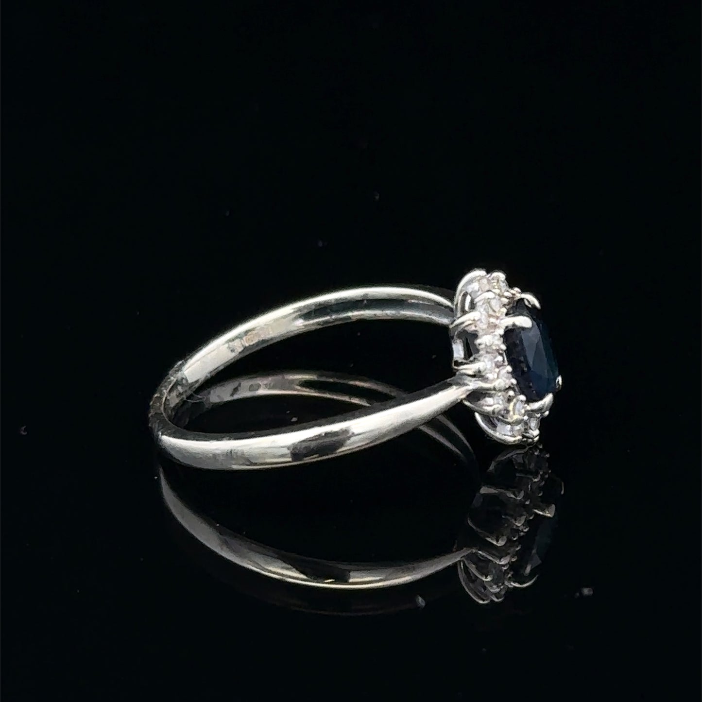 9ct white gold sapphire and diamond ring in size L, featuring a central sapphire with diamond accents, by Reeves and Sons.