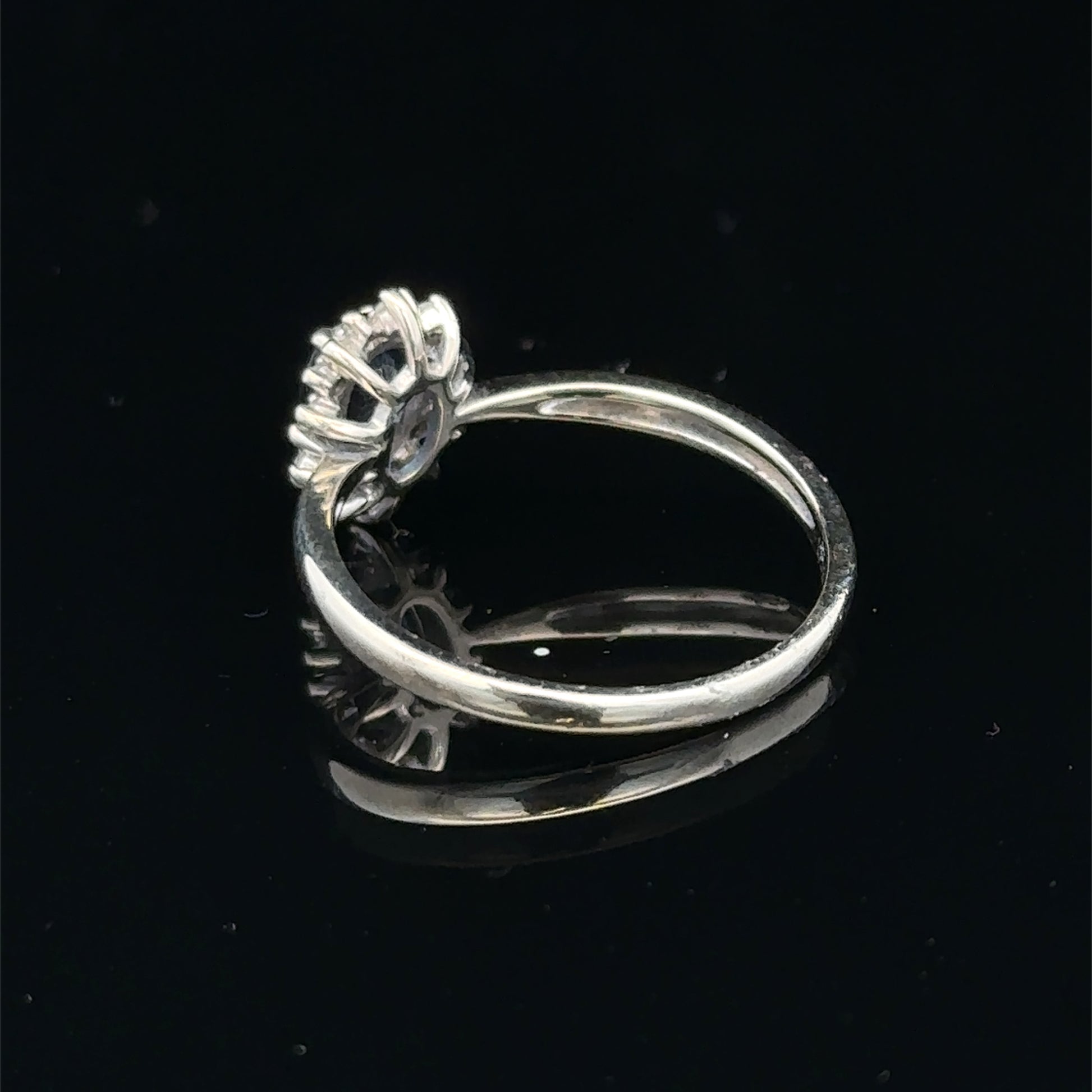 9ct white gold sapphire and diamond ring in size L, featuring a central sapphire with surrounding diamonds, by Reeves and Sons.
