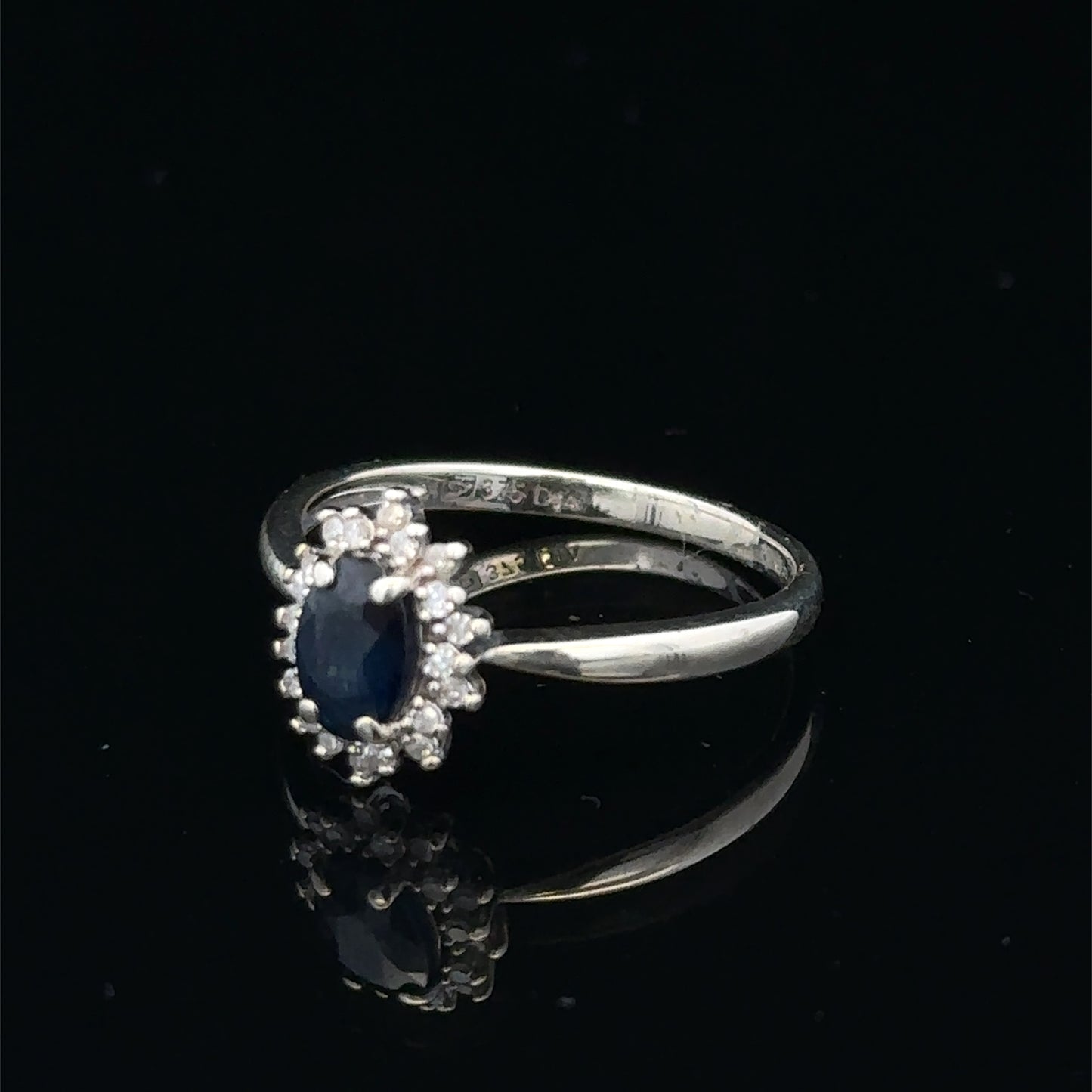 9ct white gold sapphire and diamond ring, size L, featuring a central sapphire with diamond accents, crafted by Reeves and Sons.