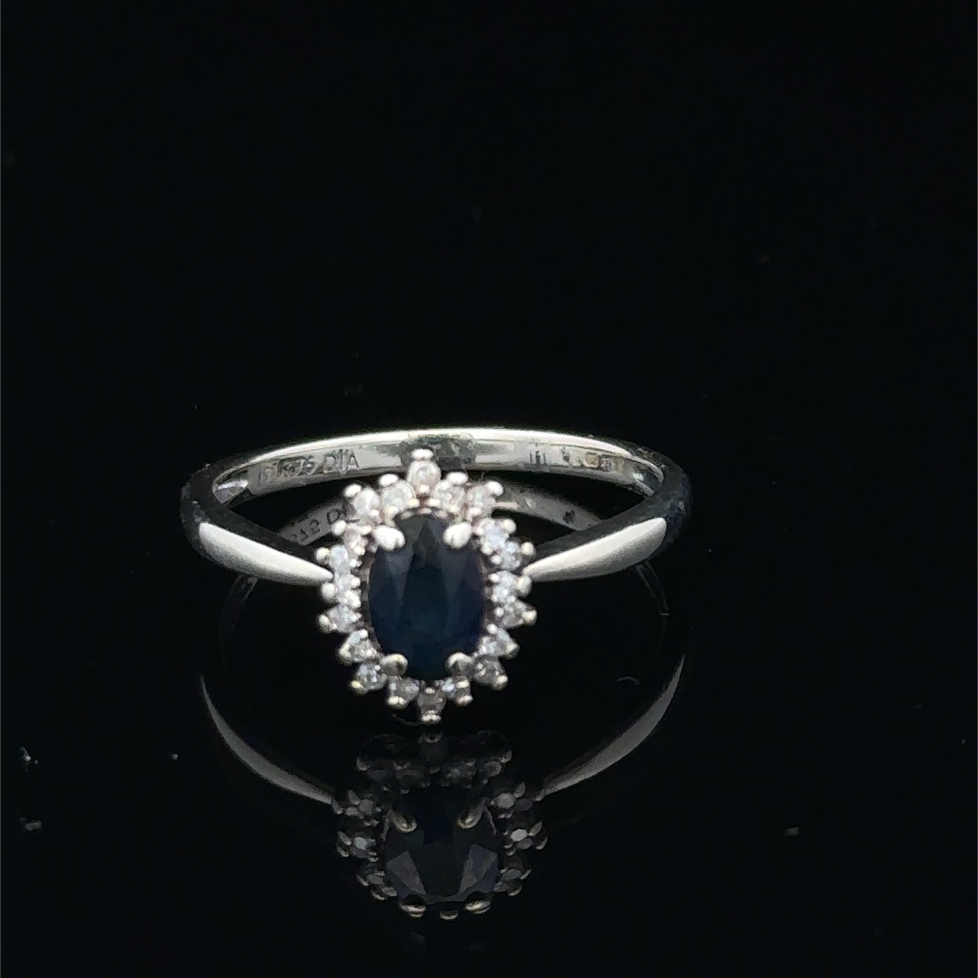 9ct white gold sapphire and diamond ring, size L, with a central sapphire gemstone and diamond accents, by Reeves and Sons.