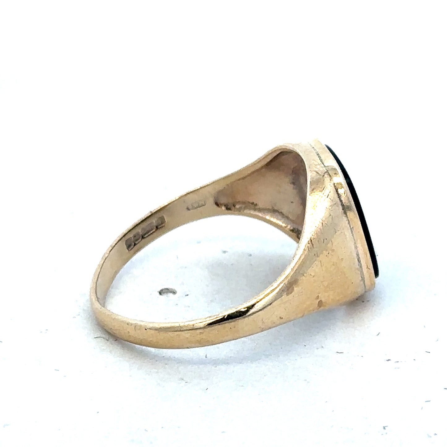 9ct yellow gold signet ring in size T with engraved face, crafted by Reeves and Sons, shown on a plain background.