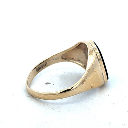 9ct yellow gold signet ring in size T with engraved face, crafted by Reeves and Sons, shown on a plain background.