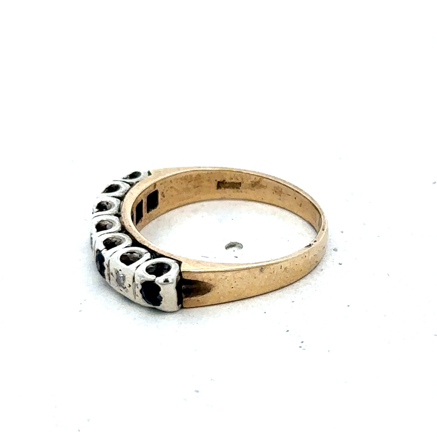 9ct yellow gold sapphire and diamond ring showing a gold band with a central sapphire and diamond accents, size K.