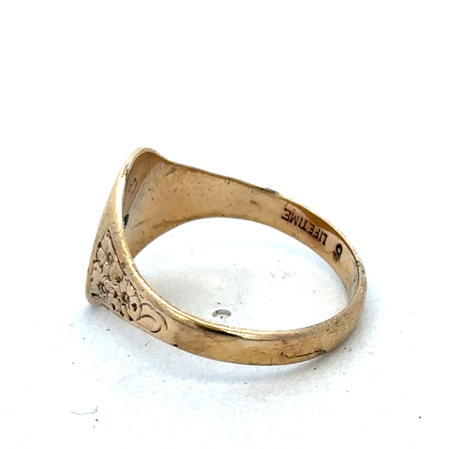 9ct yellow gold signet ring in size U with Reeves and Sons branding, featuring a smooth polished surface and classic design.