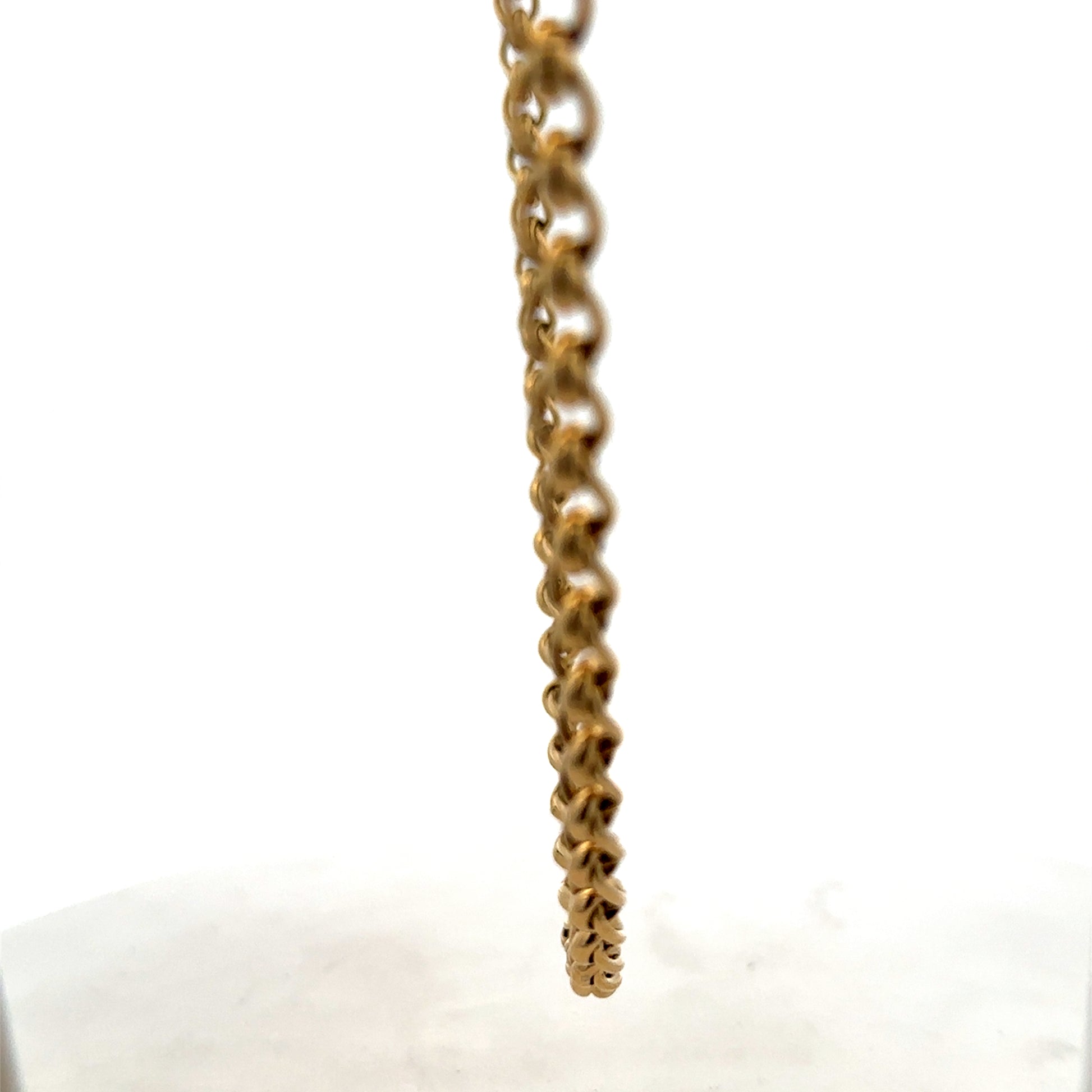 Reeves and Sons 9ct yellow gold rollerball chain, 33.9g, close-up of the shiny, textured gold chain showing its links.