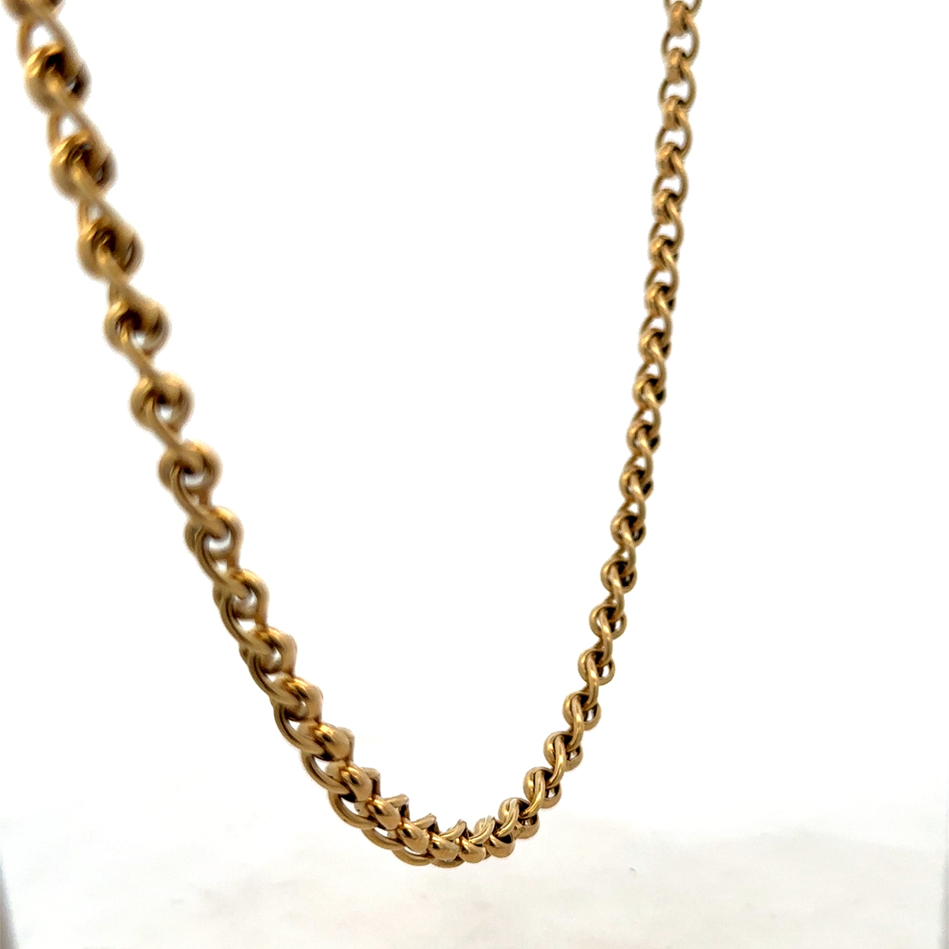Reeves and Sons 9ct yellow gold rollerball chain, 33.9g, close-up of the sleek, polished chain showing its detailed links.