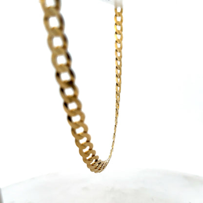 9ct yellow gold curb chain weighing 26.5g with a classic design, crafted by Reeves and Sons.