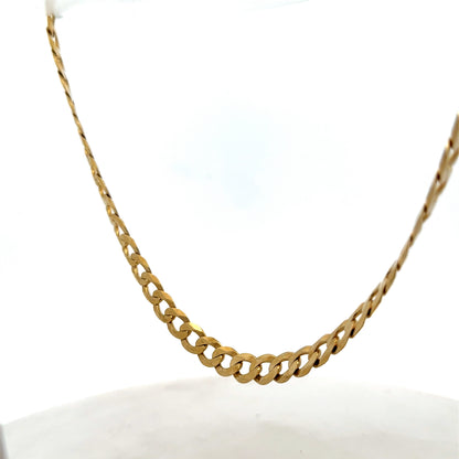 9ct yellow gold curb chain weighing 26.5g, featuring a classic link design, by Reeves and Sons, displayed on a neutral background.