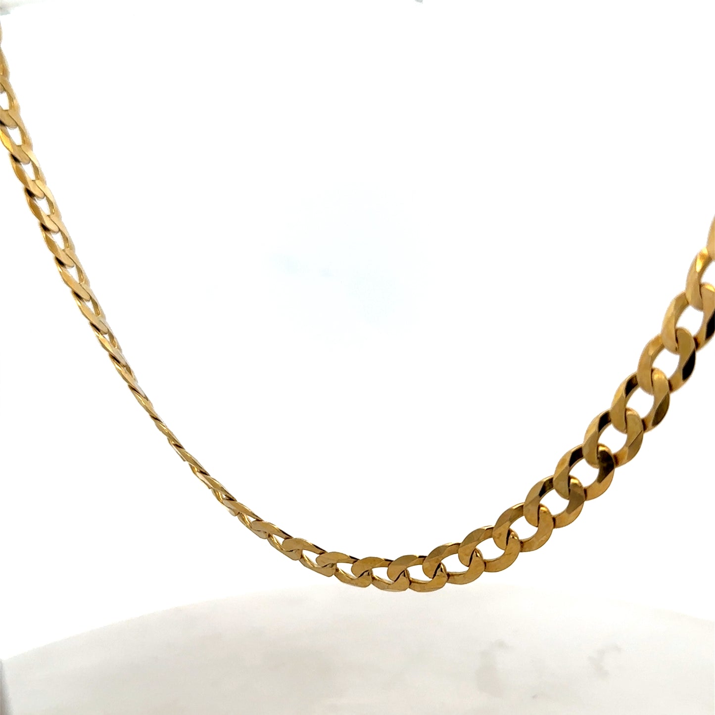 9ct yellow gold curb chain weighing 26.5g from Reeves and Sons, close-up view of the chain's links and polished finish.