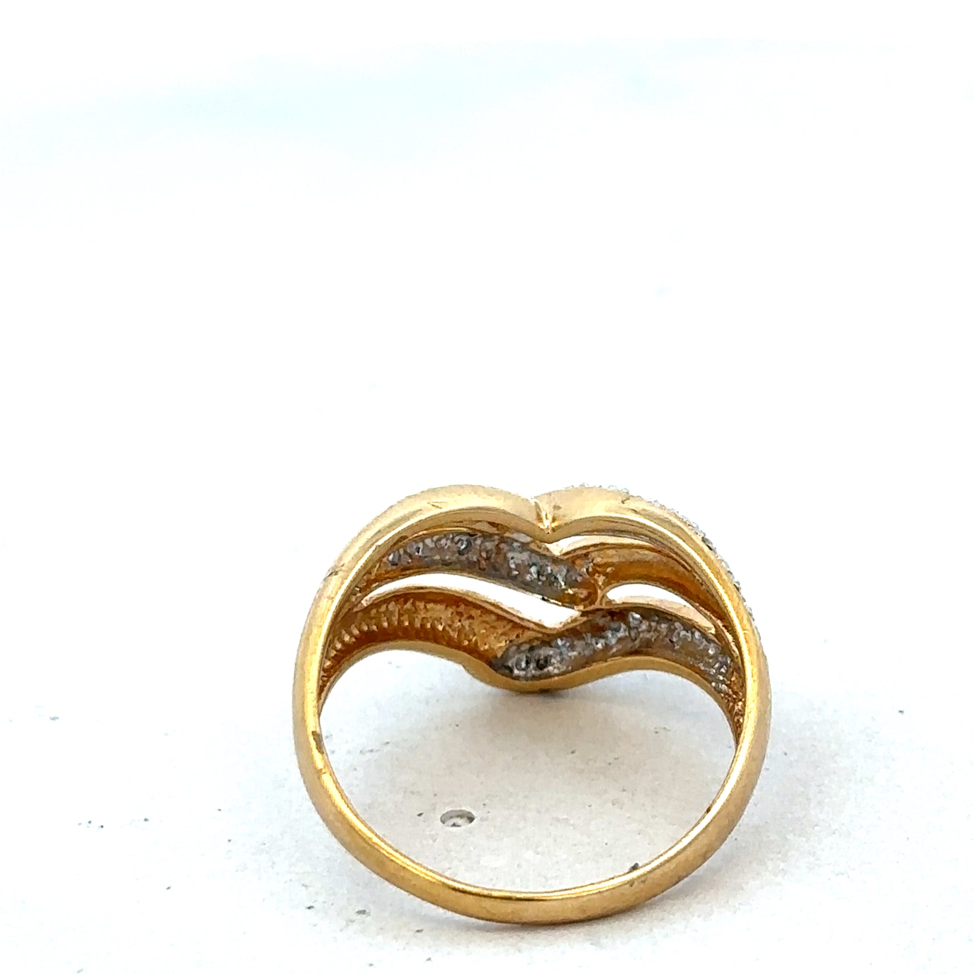 18ct yellow gold diamond ring by Reeves and Sons, featuring a sleek band with sparkling diamonds and elegant craftsmanship.