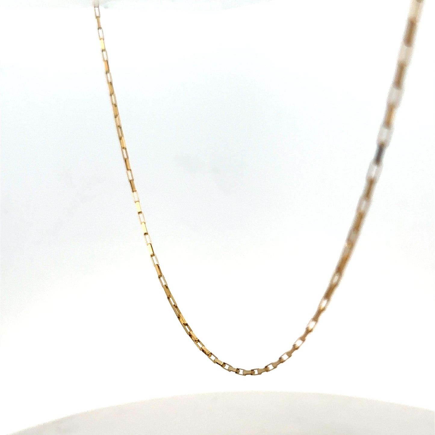 9ct yellow gold chain from Reeves and Sons, showing a delicate, shiny jewelry chain with a fine link design.