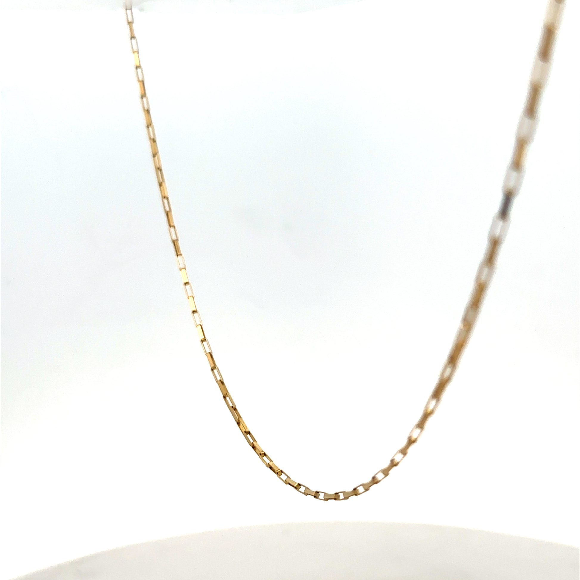 9ct yellow gold chain from Reeves and Sons, showing a delicate, shiny jewelry chain with a fine link design.