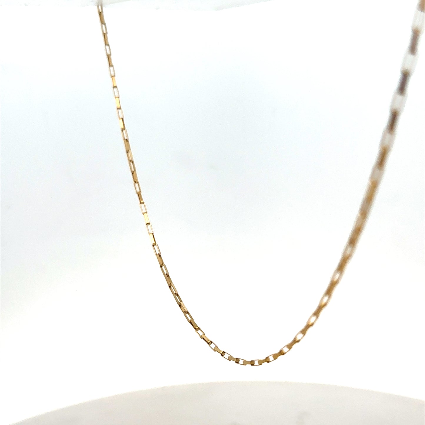 Reeves and Sons 9ct yellow gold chain, 1.8g, featuring a delicate link design visible on the chain.