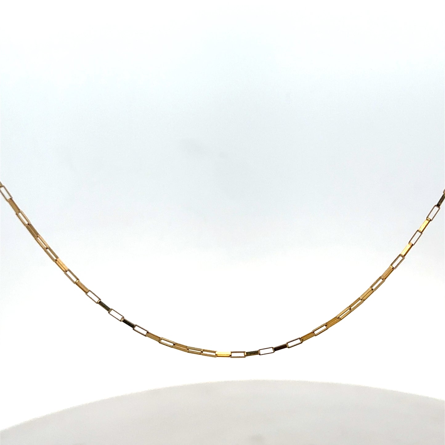 9ct yellow gold chain from Reeves and Sons, weighing 1.8g, with a delicate link design, shown in a close-up image.