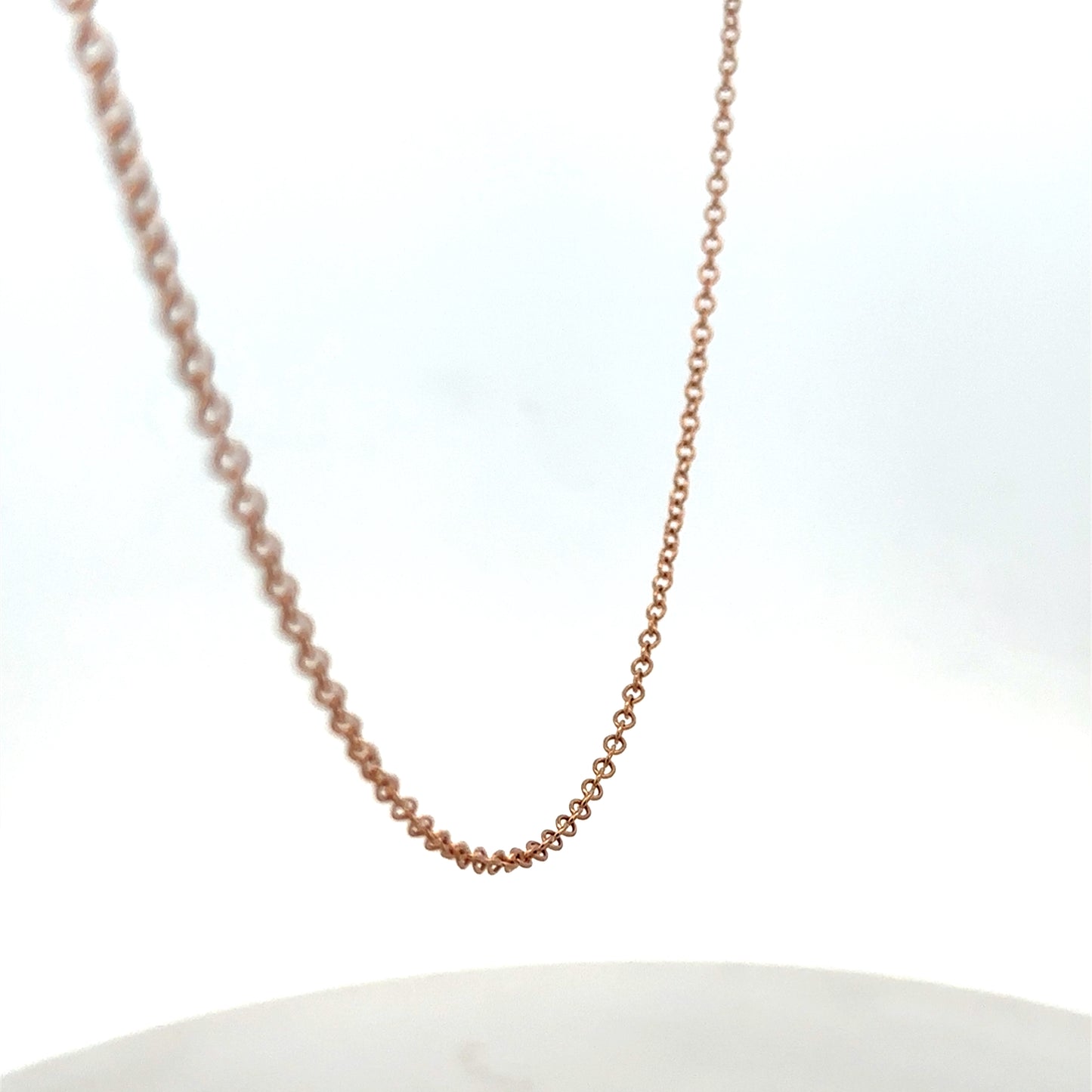 9ct gold chain weighing 4.4g with intricate link design, crafted by Reeves and Sons, displayed on a plain background.