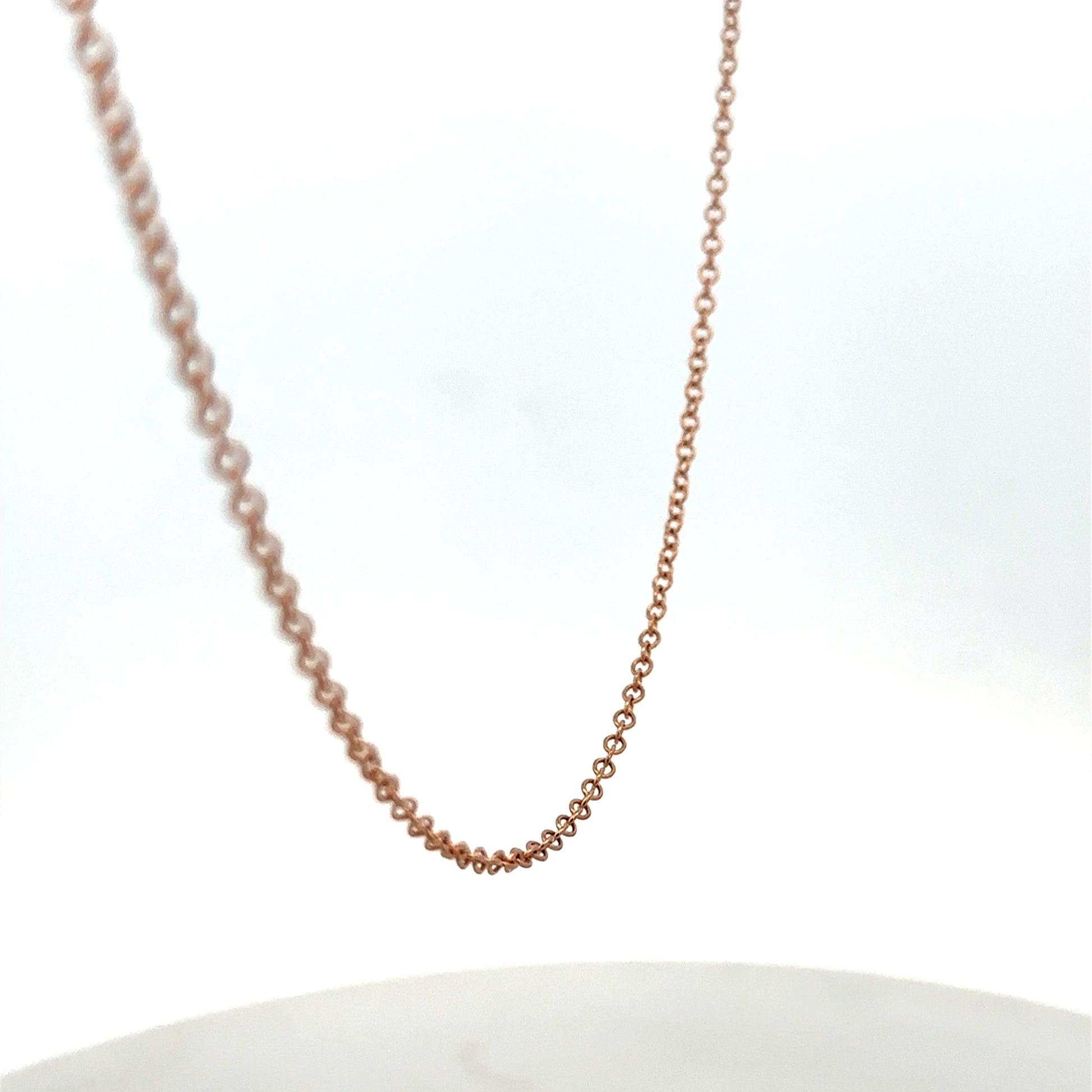 9ct gold chain weighing 4.4g with intricate link design, crafted by Reeves and Sons, displayed on a plain background.