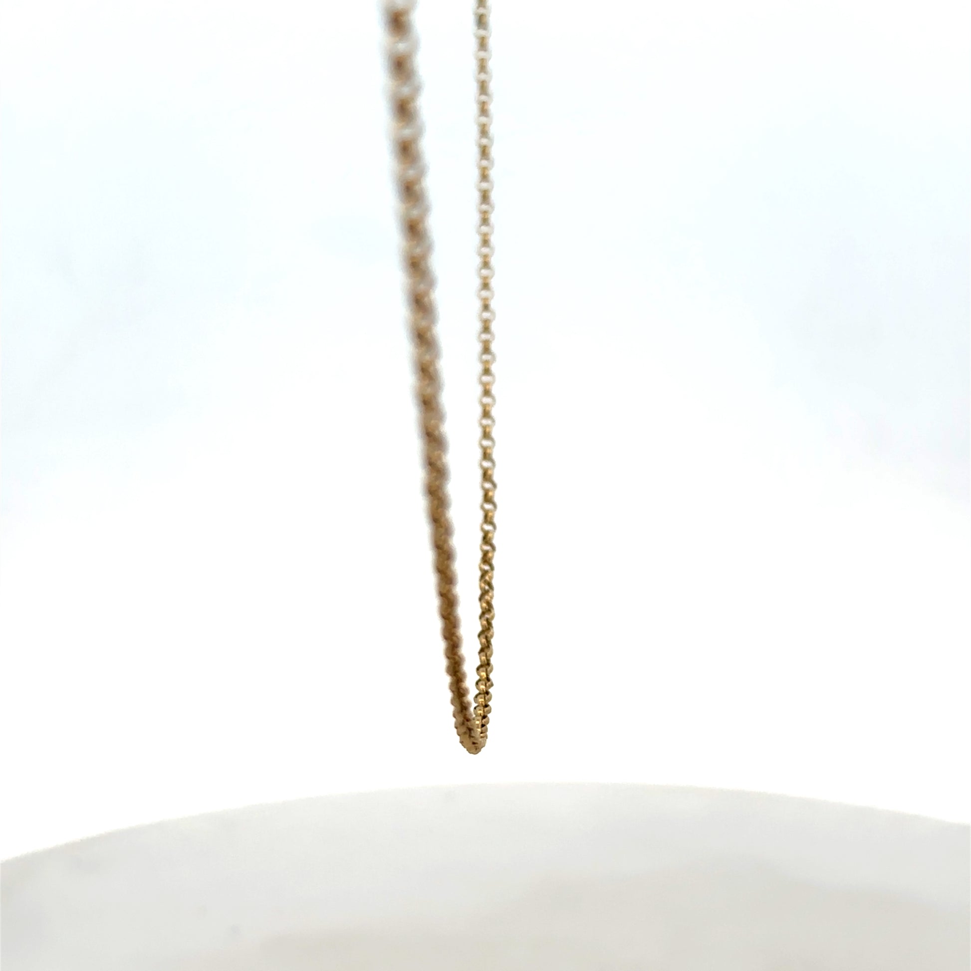9ct yellow gold belcher chain by Reeves and Sons, showing the chain's textured links and shine against a neutral background.
