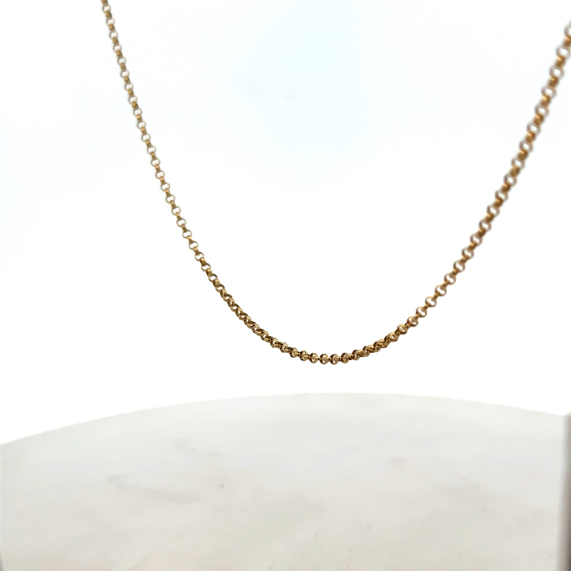 9ct yellow gold belcher chain by Reeves and Sons, showing the chain's links and shiny finish on a plain background.