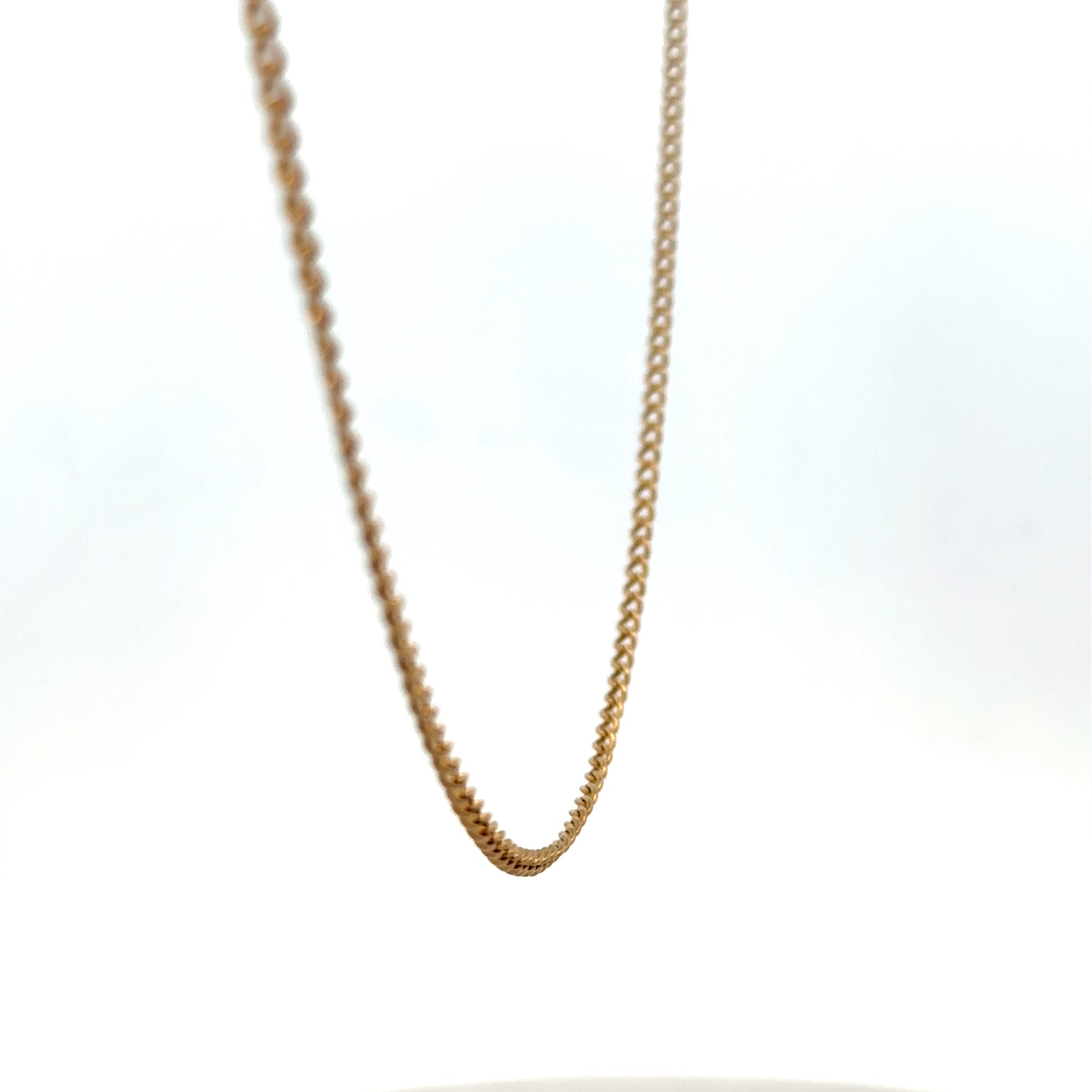 9ct yellow gold chain by Reeves and Sons, weighing 4.6g, featuring a delicate link design in a close-up shot.