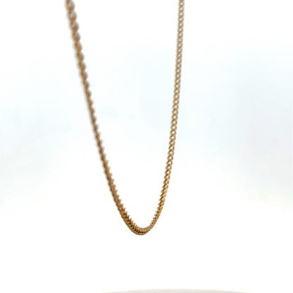 9ct yellow gold chain by Reeves and Sons, weighing 4.6g, featuring a delicate link design in a close-up shot.