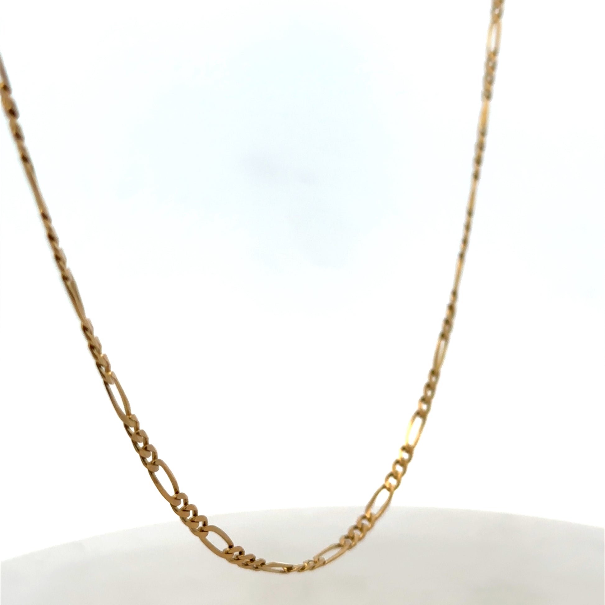 9ct yellow gold figaro chain from Reeves and Sons, showcasing its linked chain design and polished finish.