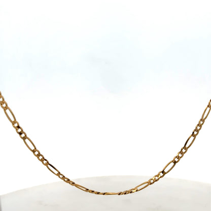 Reeves and Sons 9ct yellow gold figaro chain, 7.1g, showing the chain's detailed linked design and shiny finish.