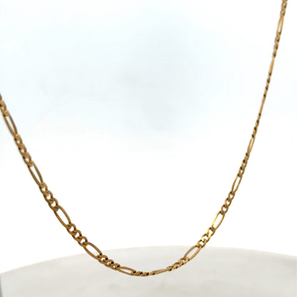 9ct yellow gold figaro chain from Reeves and Sons, showing the linked chain design and polished finish.