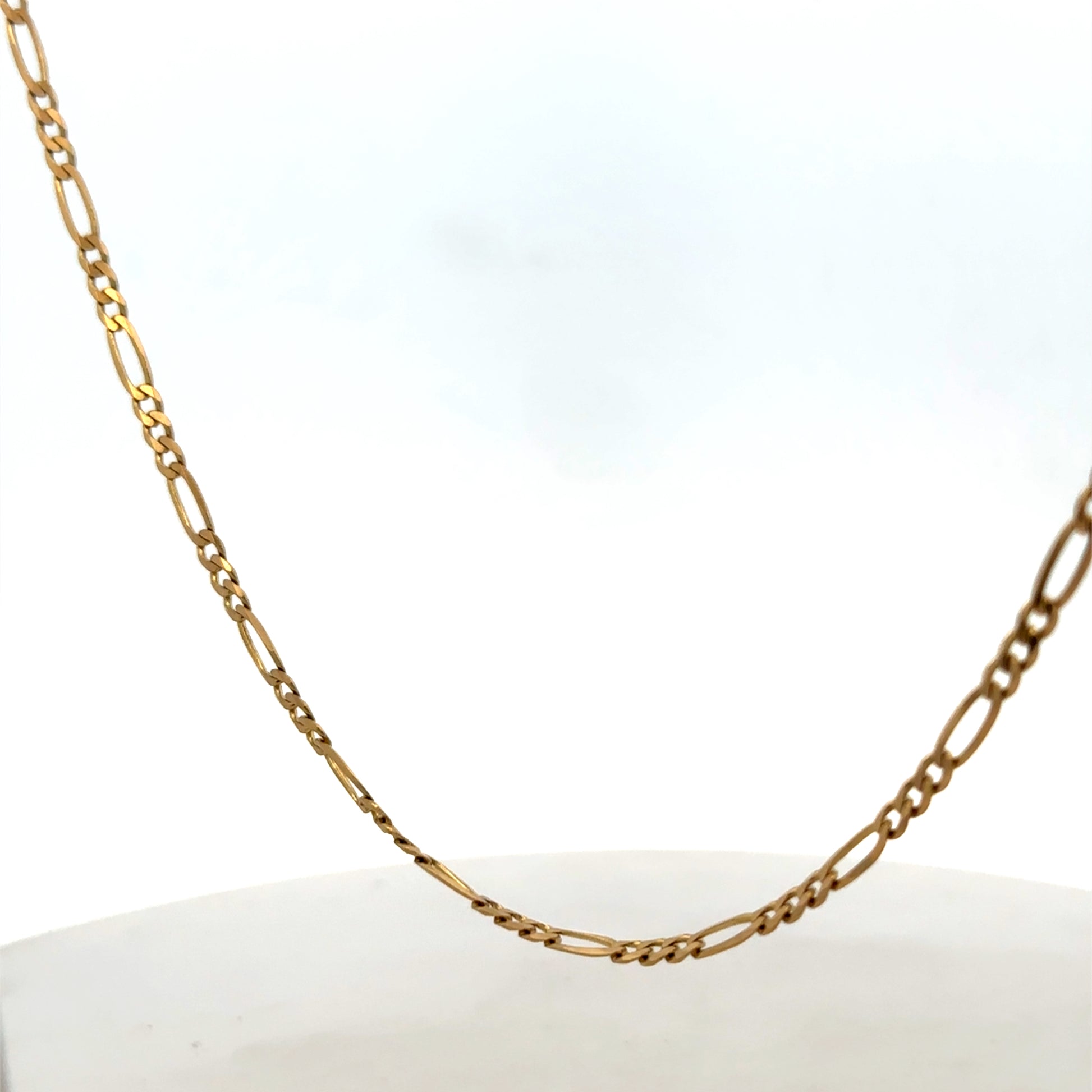 9ct yellow gold Figaro chain from Reeves and Sons, showing a close-up of the linked chain design on a white background.