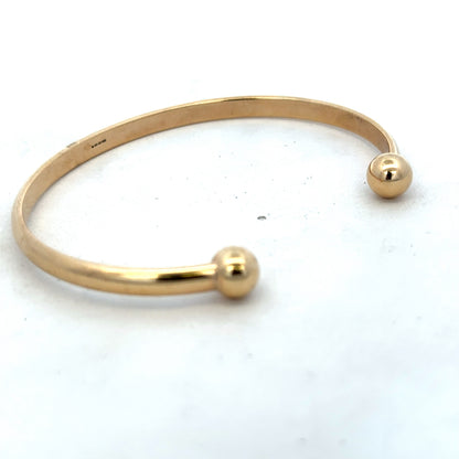 Reeves and Sons 9ct yellow gold bracelet bangle weighing 16.1g, with a smooth polished finish and classic design.