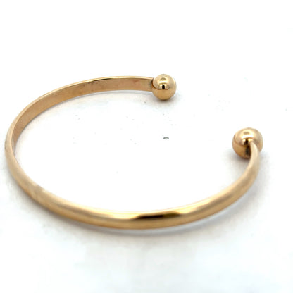 Elegant 9ct yellow gold bracelet by Reeves and Sons, 16.1g, showcasing a smooth, polished bangle design.