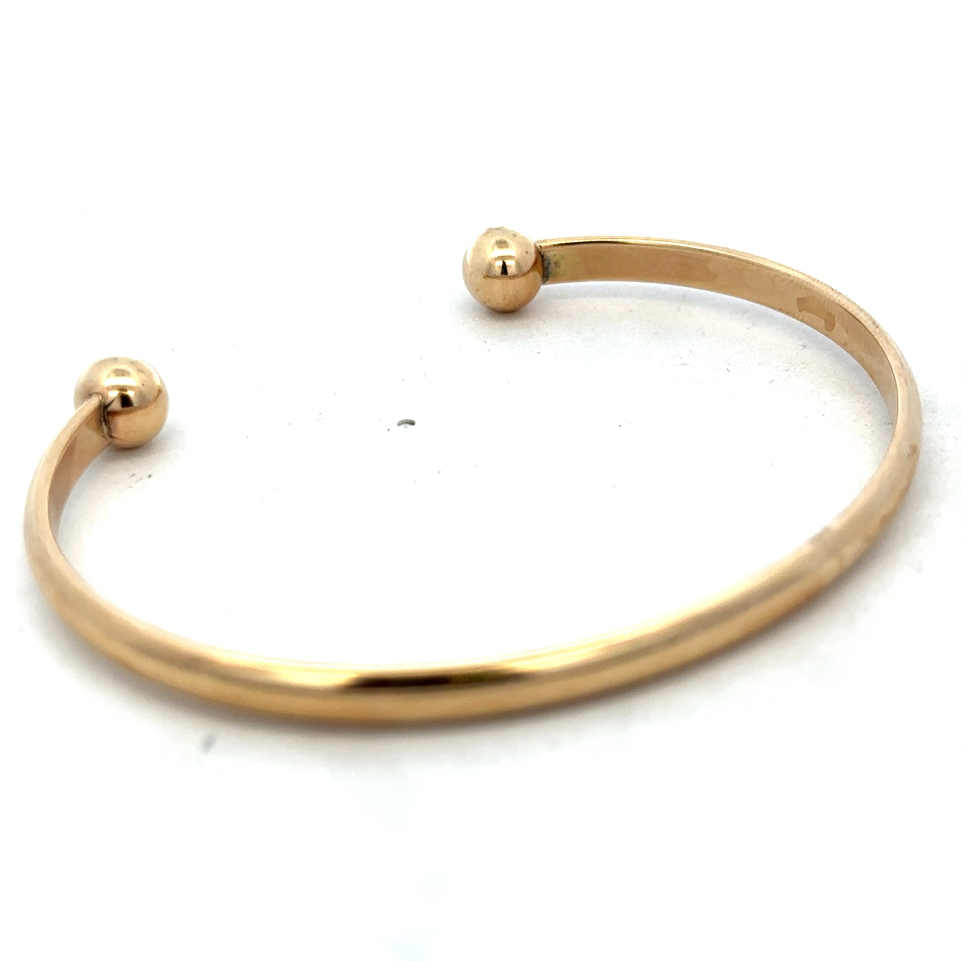 9ct yellow gold bracelet bangle weighing 16.1g, from Reeves and Sons, featuring a smooth, polished finish and classic design.