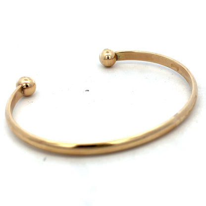 9ct yellow gold bracelet bangle weighing 16.1g, from Reeves and Sons, featuring a smooth, polished finish and classic design.