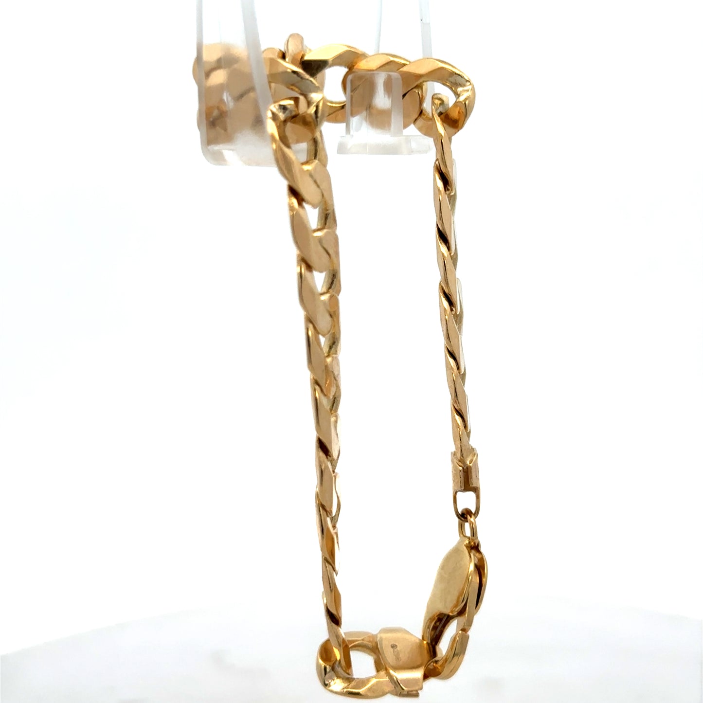 9ct yellow gold curb bracelet weighing 29.9g with Reeves and Sons branding, featuring polished interlinked chain links.