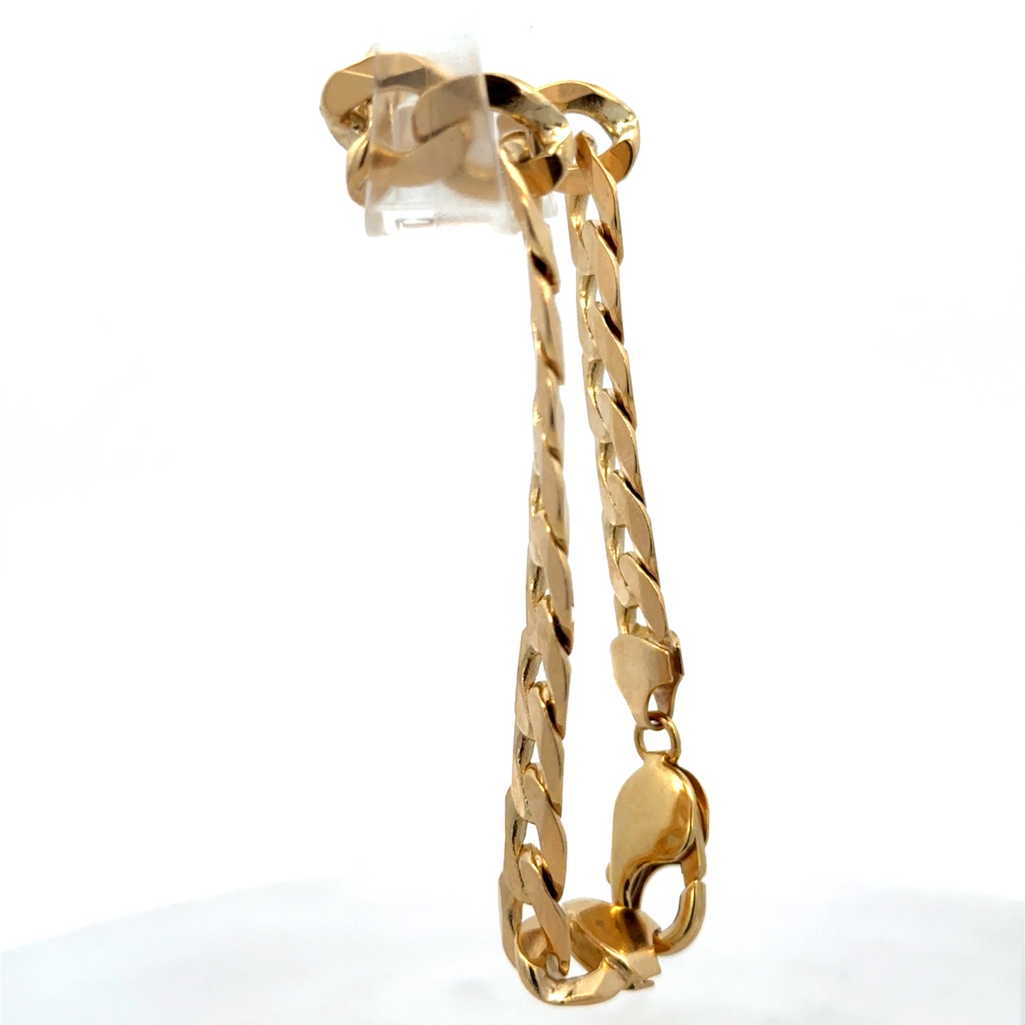 9ct yellow gold curb bracelet weighing 29.9g with a polished finish, crafted by Reeves and Sons.