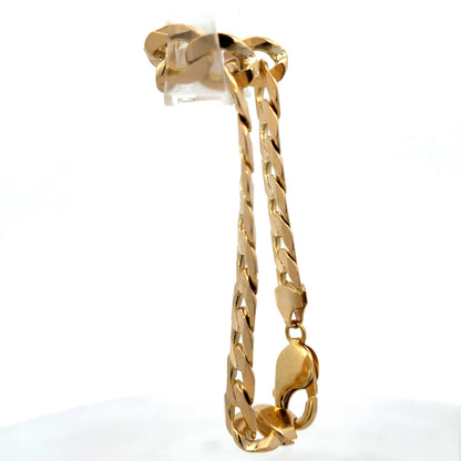 9ct yellow gold curb bracelet weighing 29.9g with a polished finish, crafted by Reeves and Sons.