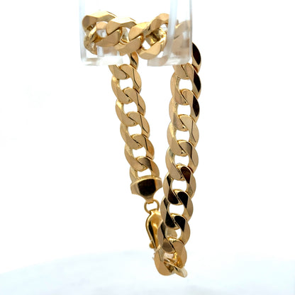 9ct yellow gold curb bracelet weighing 29.9g with a polished finish, featuring classic chain links, by Reeves and Sons.