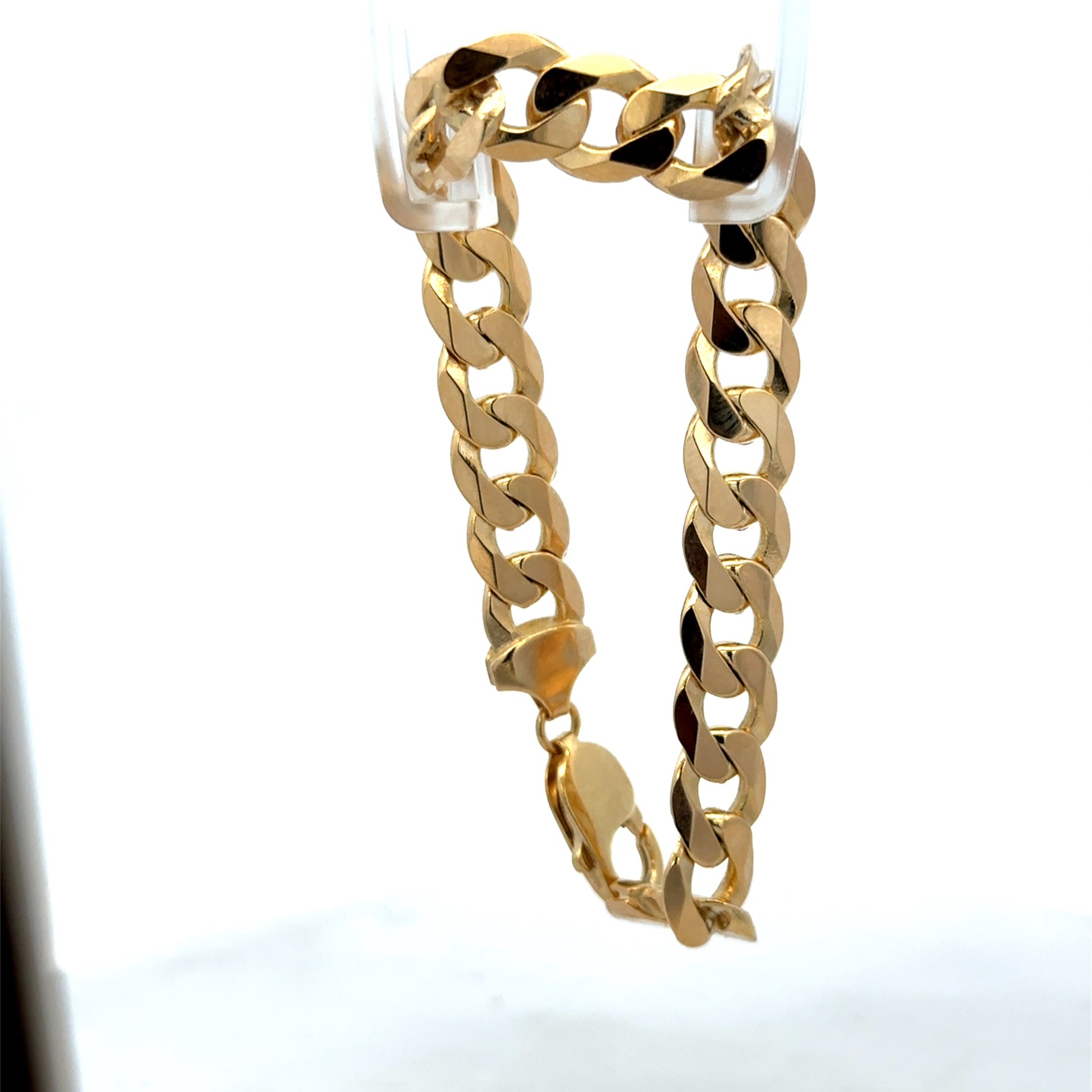 Reeves and Sons 9ct yellow gold curb bracelet weighing 29.9g, featuring interlinked flat chain design.