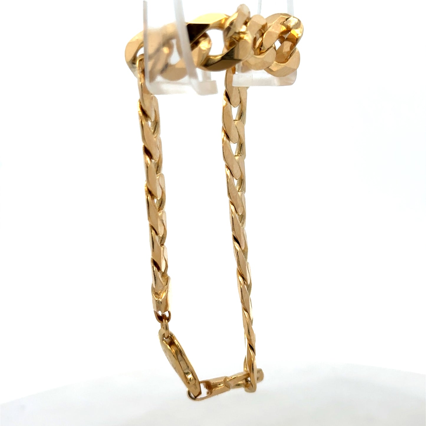 9ct yellow gold curb bracelet weighing 29.9g with intricate links, crafted by Reeves and Sons, displayed on a neutral background.
