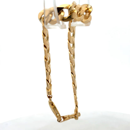 9ct yellow gold curb bracelet weighing 29.9g with intricate links, crafted by Reeves and Sons, displayed on a neutral background.