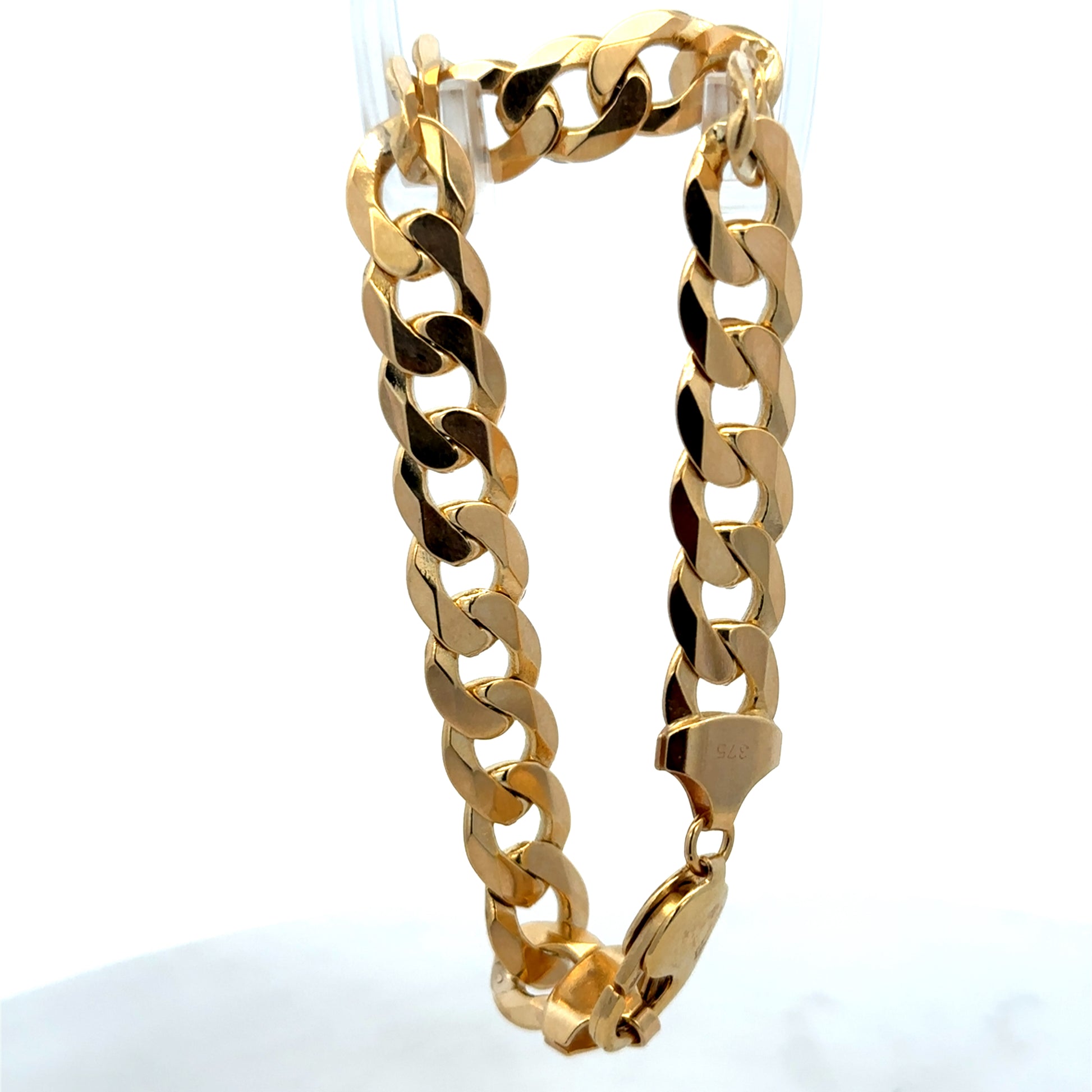 9ct yellow gold curb bracelet weighing 29.9g with a polished finish, featuring interlinked flat oval links from Reeves and Sons.