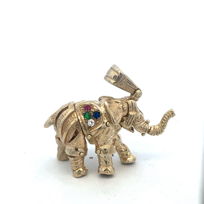 9ct yellow gold elephant pendant with detailed design, weighs 25.3g, by Reeves and Sons, displayed on a plain background.