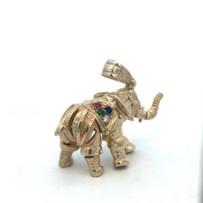9ct yellow gold elephant pendant, detailed design, weight 25.3g, from Reeves and Sons, displayed on a plain background.