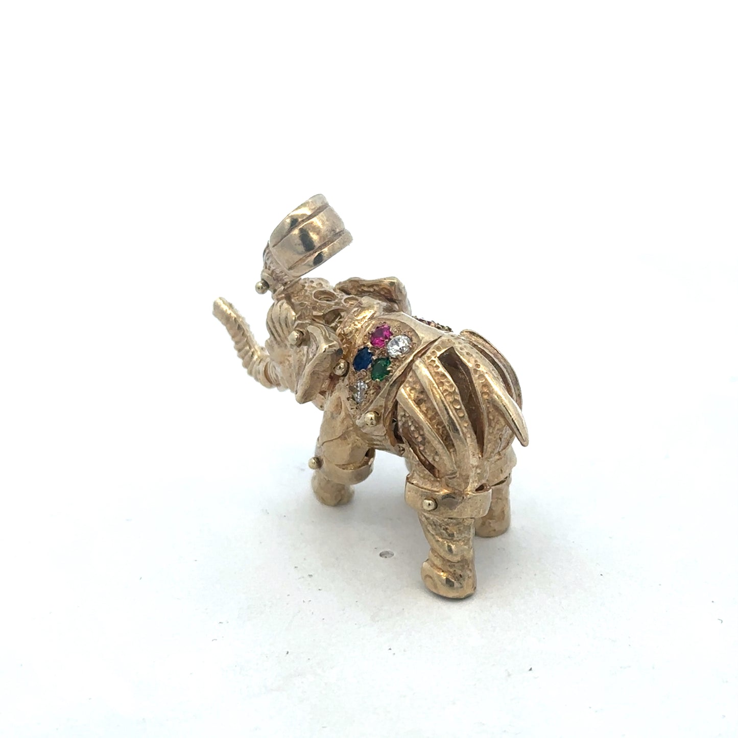 9ct yellow gold elephant pendant from Reeves and Sons, weighs 25.3g, with detailed elephant design, shown in close-up image.