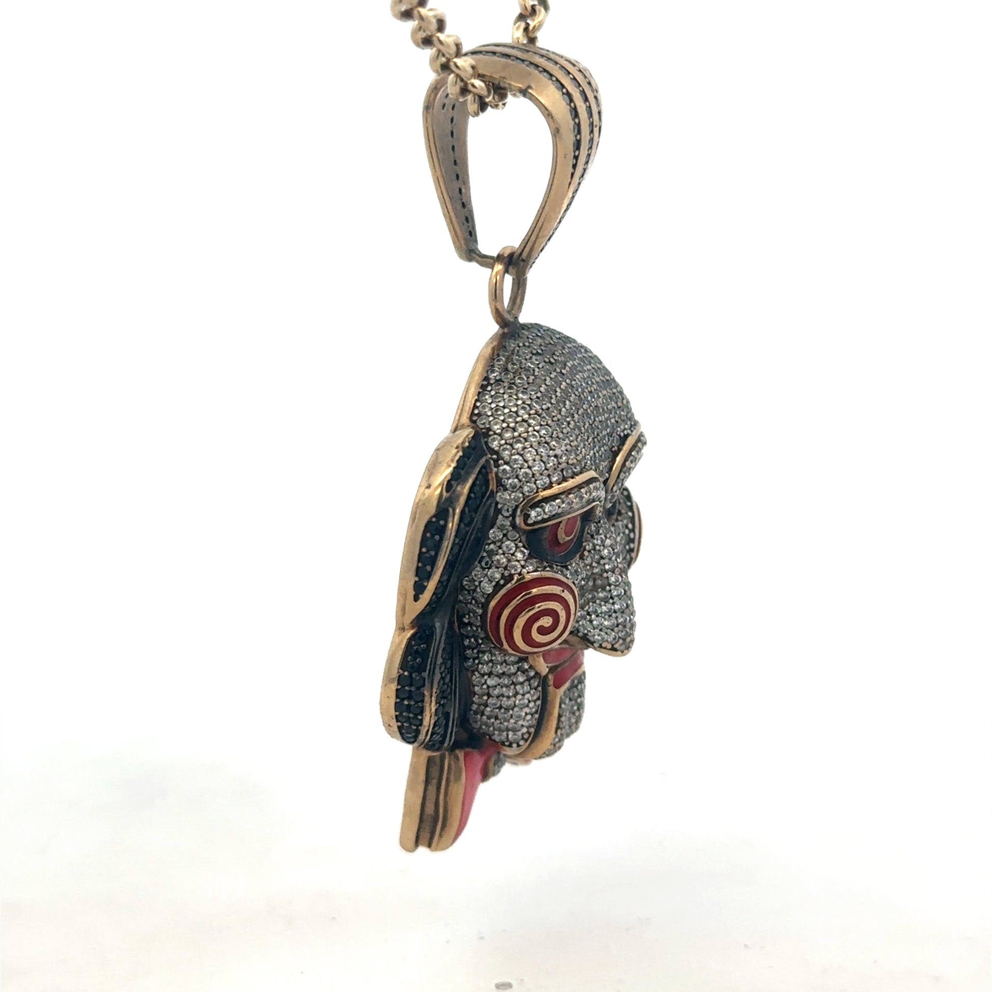 9ct yellow gold jigsaw pendant by Reeves and Sons, detailed design with polished finish, shown on a plain background.