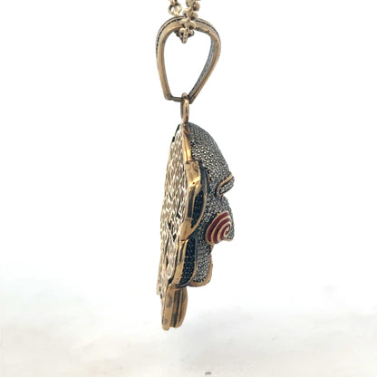 9ct yellow gold jigsaw pendant with Reeves and Sons branding, featuring intricate puzzle piece design and polished finish.