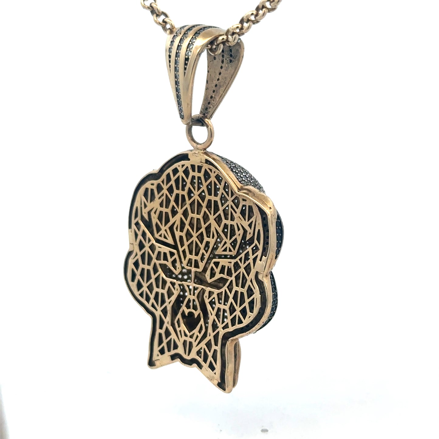 9ct yellow gold jigsaw pendant showing intricate design and polished finish, weighing 24.1g, by Reeves and Sons.