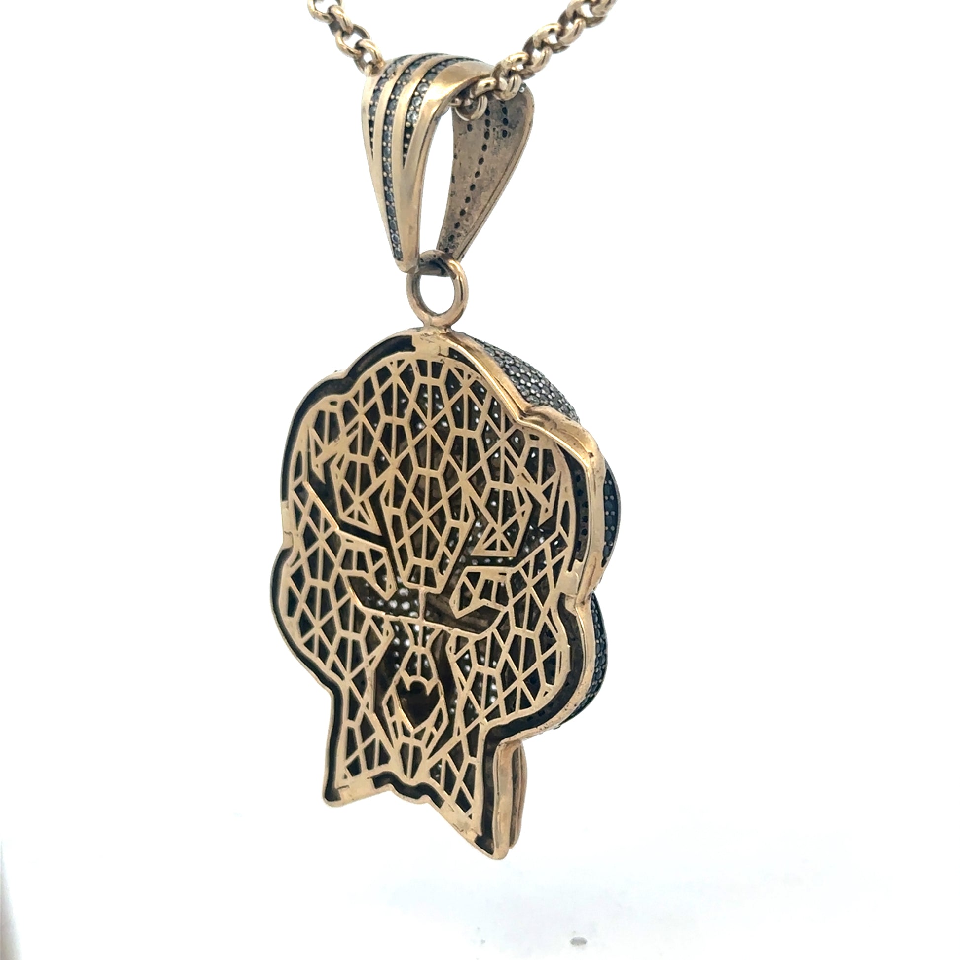 9ct yellow gold jigsaw pendant showing intricate design and polished finish, weighing 24.1g, by Reeves and Sons.