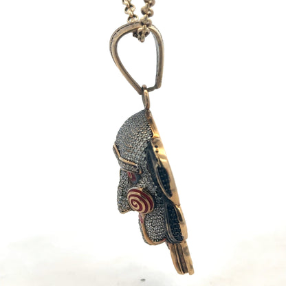9ct yellow gold jigsaw pendant with Reeves and Sons branding, showcasing intricate puzzle-piece design and polished finish.